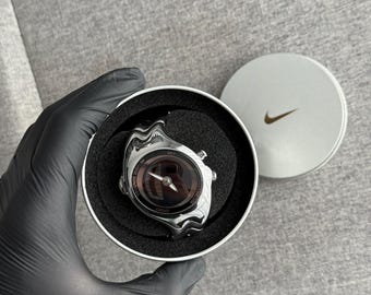The Nike Triax Armored Chrono watch is a classic model with an innovative design, a retro-inspired accessory silver chrome avantgarde y2k