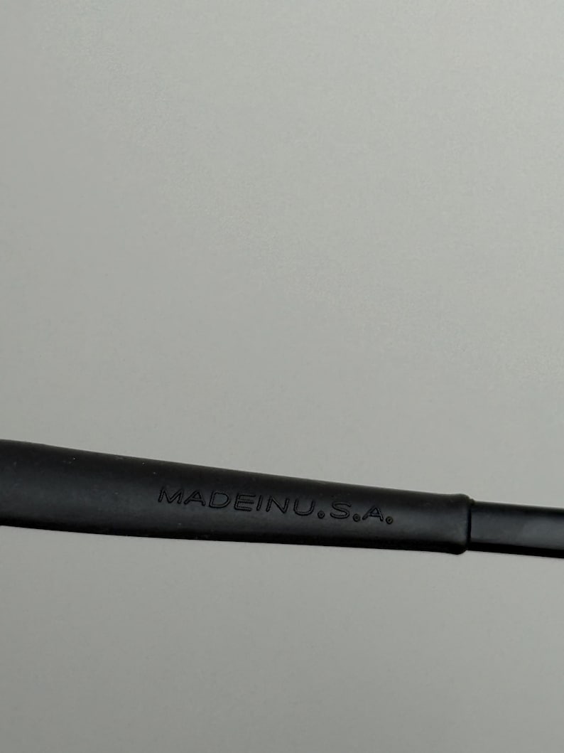 May include: Close-up of a black object with the text "MADE IN U.S.A." in white. The object appears to be a part of a larger item, possibly a tool or accessory.