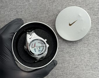 The Nike Triax Armored Chrono watch is a classic model with an innovative design, a retro-inspired accessory silver chrome avantgarde y2k