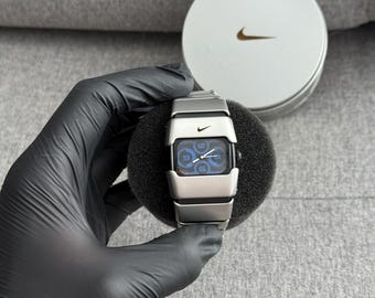 The Nike D-Line Armored watch is a classic model with an innovative design, a retro-inspired accessory silver box case avantgarde y2k
