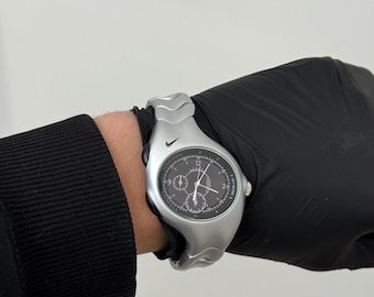 The Nike Triax Armored Chrono watch is a classic model with an innovative design, a retro-inspired accessory silver avantgarde y2k