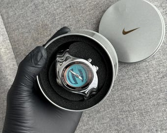The Nike Triax Armored Chrono watch is a classic model with an innovative design, a retro-inspired accessory silver chrome avantgarde y2k