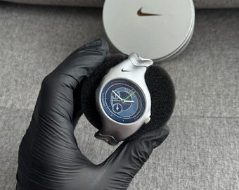 The Nike Triax Armored Chrono watch is a classic model with an innovative design, a retro-inspired accessory silver avantgarde y2k