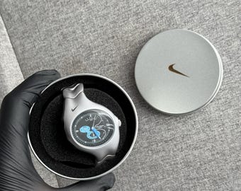 The Nike Triax Armored Chrono watch is a classic model with an innovative design, a retro-inspired accessory silver box case avantgarde y2k