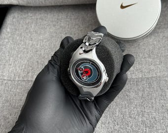 The Nike Triax Armored Chrono watch is a classic model with an innovative design, a retro-inspired accessory silver avantgarde y2k chrome