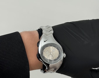 The Nike Triax Armored Chrono watch is a classic model with an innovative design, a retro-inspired accessory silver chrome avantgarde y2k