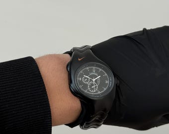 The Nike Triax Armored Chrono watch is a classic model with an innovative design, a retro-inspired accessory silver black avantgarde y2k