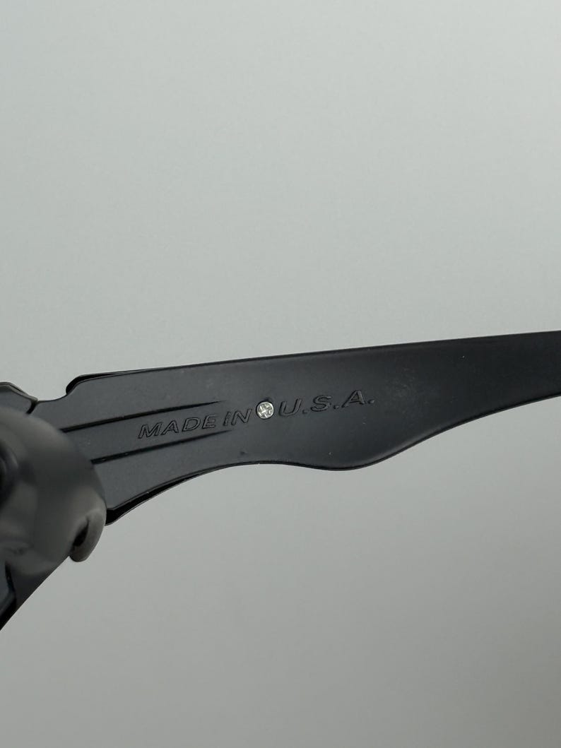 May include: Close-up of a black object with the text "MADE IN U.S.A." printed on it. The object has a sleek, modern design and appears to be made of a durable material. The text is in a clear, easy-to-read font.