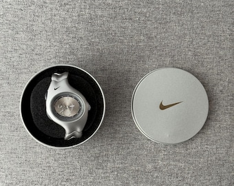 The Nike Triax Armored Chrono watch is a classic model with an innovative design, a retro-inspired accessory silver box case avantgarde y2k