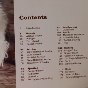May include: A book titled "Contents" with a list of dog breeds and page numbers. The breeds are categorized into Hounds, Terriers, Sporting, Non-Sporting, and Working.