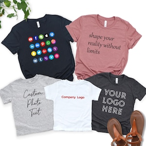 a collection of five t-shirts, each with a unique design and text, arranged on a white background.