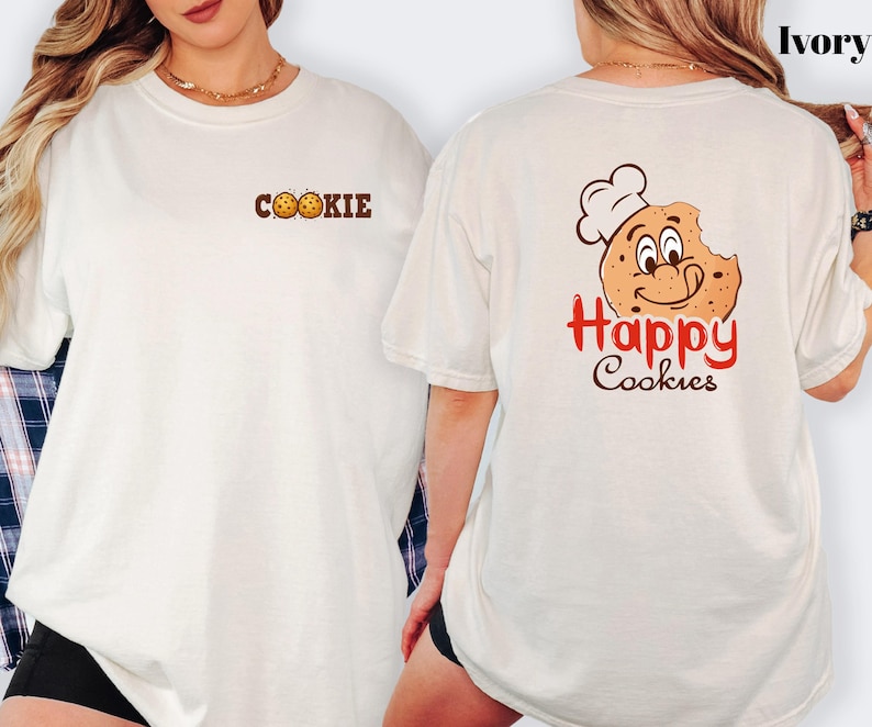 A woman wearing a white t-shirt with a cookie and happy cookie graphic on the back.