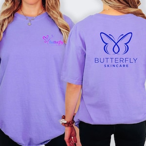 a woman wearing a purple t-shirt with a butterfly logo and text on the back.