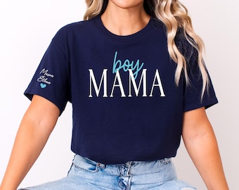 May include: Navy blue t-shirt with the words "boy MAMA" in white and teal lettering. The names "Mason" and "Ethan" are printed on the left sleeve, with a teal heart. The shirt is a casual style.