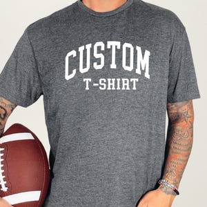 May include: A heather grey t-shirt with the text "CUSTOM T-SHIRT" in white.