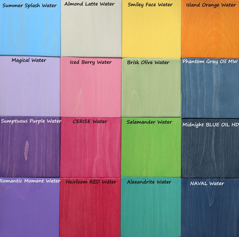 May include: A grid of sixteen wooden squares, each painted a different color. The colors include light blue, beige, yellow, orange, lavender, pink, green, and various shades of purple, red, and blue. Each square has a label with a color name, such as "Summer Splash Water."