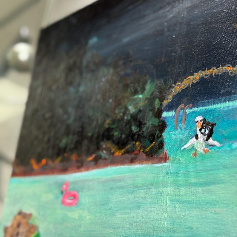 May include: An acrylic painting depicting a nighttime beach scene. The artwork features a dark blue sky, turquoise water, and a dark green tree line. A pink flamingo float and a small figure of a penguin are visible in the water.