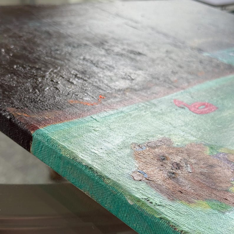 May include: Close-up of a textured painting on canvas. The artwork features a dark brown and gray section, a light green area, and a red abstract shape. The edges of the canvas are a darker green.