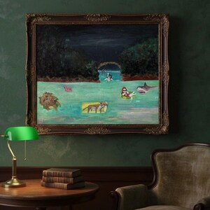 May include: An oil painting in a dark ornate frame depicts a whimsical scene of figures and animals floating in water. A shark, a person in a floatie, and other creatures are in the water. The painting hangs above a round table with books and a green lamp.