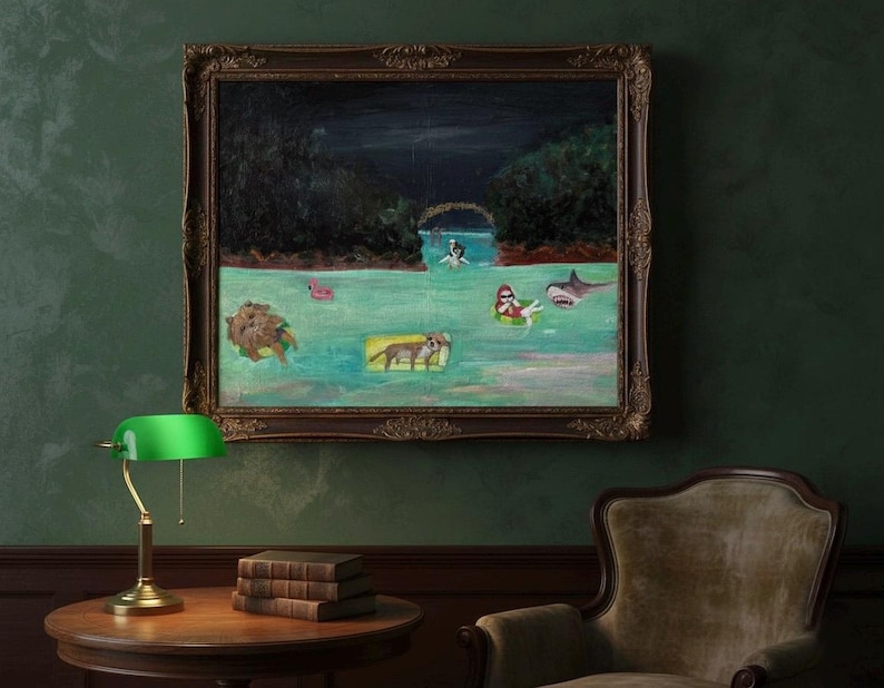 May include: An oil painting in a dark ornate frame depicts a whimsical scene of figures and animals floating in water. A shark, a person in a floatie, and other creatures are in the water. The painting hangs above a round table with books and a green lamp.