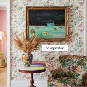 May include: A room with floral wallpaper, a framed painting, and a patterned armchair. A round table holds a vase with dried plants and a stack of books. The text "For inspiration" is visible.