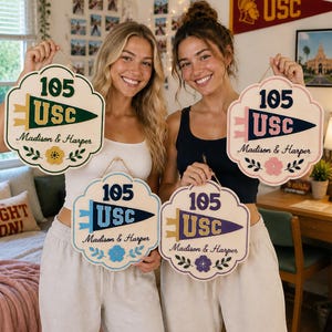 May include: Four scalloped wooden wall signs featuring the text 105 USC and Madison & Harper. Each sign displays a unique color scheme with a pennant graphic and floral accents, suspended by a thin twine cord for hanging on a wall surface.