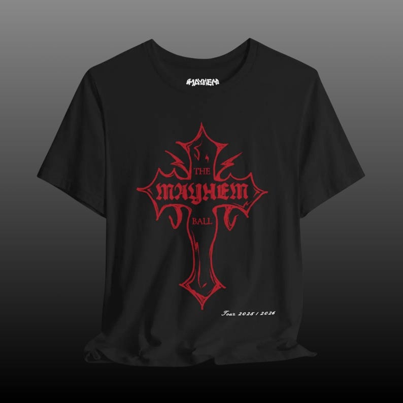 May include: Black t-shirt featuring a red graphic of a cross with the words "The Mayhem Ball" and "Tour 2025/2026". The word "Mayhem" is printed in white at the top of the shirt.