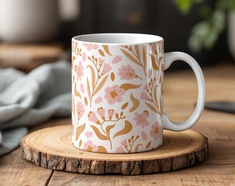 May include: White ceramic mug with a floral pattern. The pattern features pink and brown flowers and leaves on a white background.