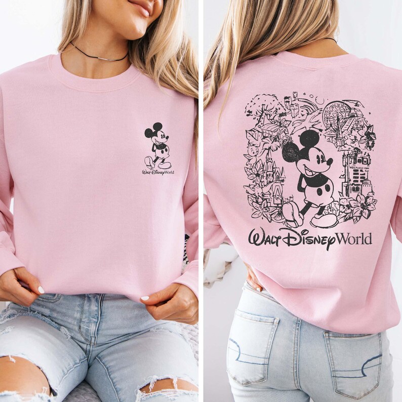 May include: Pink sweatshirt with a black Mickey Mouse graphic on the front and a black Mickey Mouse graphic with a Walt Disney World logo on the back.