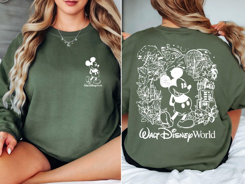 May include: A green sweatshirt with a white graphic of Mickey Mouse on the front and a larger white graphic of Mickey Mouse and the text "Walt Disney World" on the back.