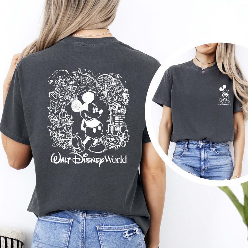 May include: A dark gray t-shirt with a white graphic of Mickey Mouse and various Disney World landmarks. The text "Walt Disney World" is printed below the graphic.