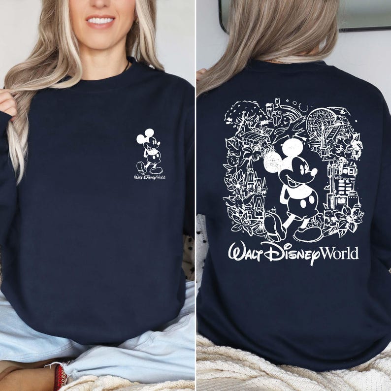 May include: A navy blue sweatshirt with a white outline of Mickey Mouse and the text "Walt Disney World" on the front. The back of the sweatshirt features a white outline of Mickey Mouse surrounded by a design of various Disney World attractions.