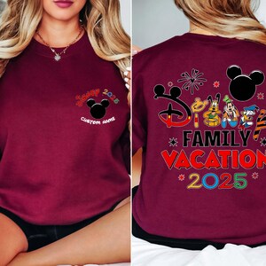 May include: Burgundy sweatshirt with a Mickey Mouse design and the text "Disney Family Vacation 2025." The front features a Mickey Mouse head and the text "Custom Name." The back has Disney characters.