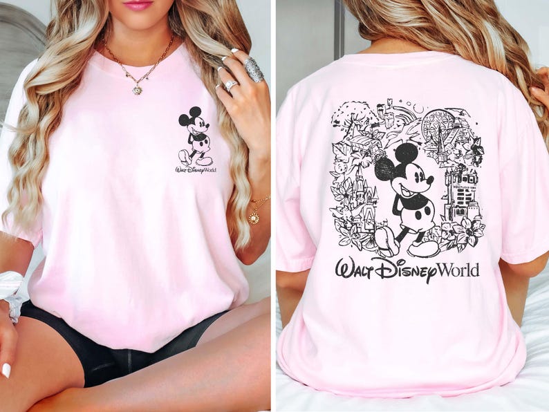 May include: Pink t-shirt with a black and white Mickey Mouse graphic on the front and a larger black and white Mickey Mouse graphic with a park scene on the back. The text "Walt Disney World" is printed on the back of the shirt.