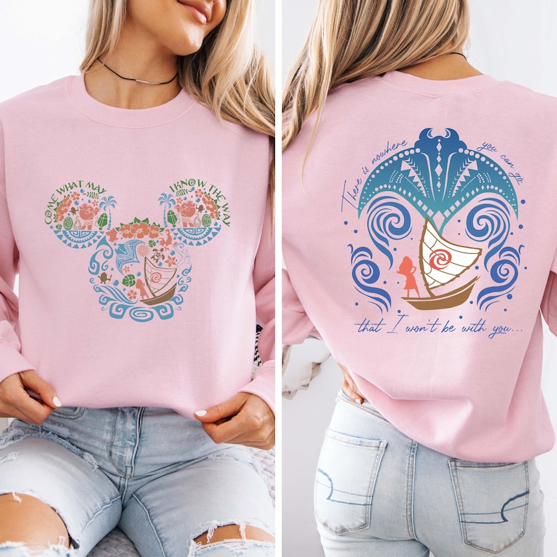May include: Pink sweatshirt with a Mickey Mouse silhouette design featuring a Polynesian inspired pattern and the text "Come What May" and "I Know The Way". The back of the sweatshirt has a blue and green design with a boat and the text "There is nowhere you can go that I won't be with you..."