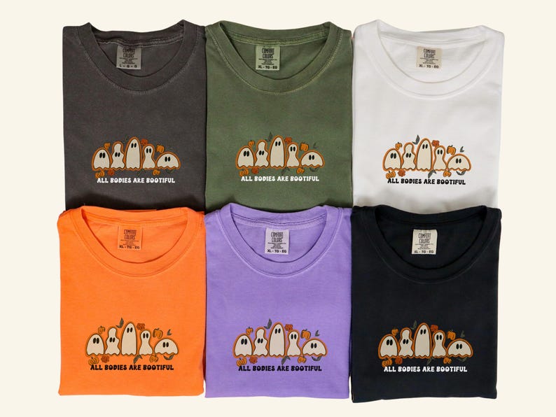 Comfort Colors® shirts with five different-shaped ghosts surrounded by pumpkins and flowers, featuring the phrase “All Bodies Are Bootiful”