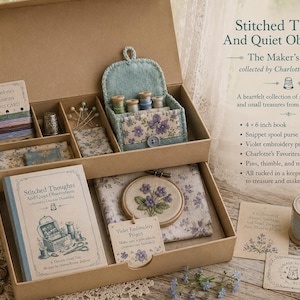 May include: A cardboard keepsake box containing a 4x6 inch book titled Stitched Thoughts And Quiet Observations, a violet embroidery project in a hoop, a floss card, pins, a thimble, a fabric spool purse project, and assorted fabric pieces.