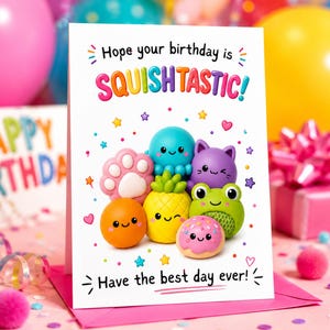 May include: A white birthday greeting card with the text "Hope your birthday is SQUISHTASTIC!" and "Have the best day ever!" featuring colourful illustrations of a pink paw, blue octopus, purple cat, orange ball, yellow pineapple, green frog, and pink doughnut.