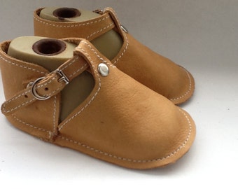 Tan leather baby shoe with buckle and rivet