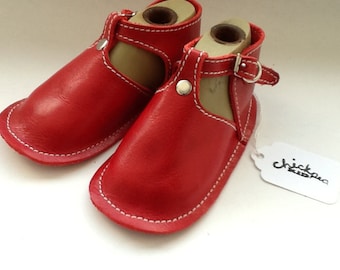 Red leather baby shoe with buckle and rivet