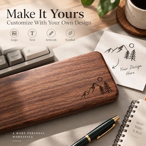 May include: A rectangular dark brown wooden keyboard wrist rest featuring a laser-engraved mountain and pine tree graphic. The text "Make It Yours Customize With Your Own Design" is visible along with icons for logo, text, artwork, and symbol.