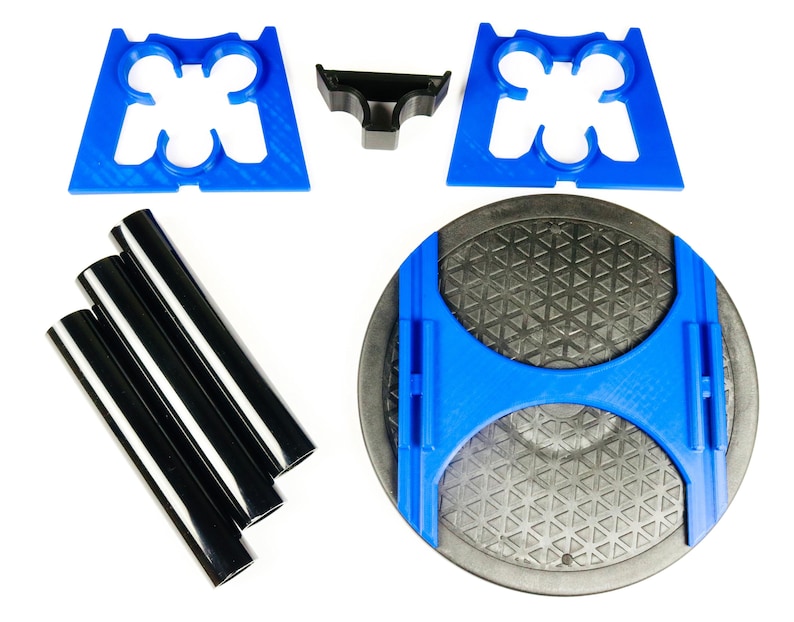 May include: An assortment of 3D-printed parts in blue and black, including support brackets, a small connector, and several cylindrical rods. The parts are arranged on a white background, suggesting a kit or set of components.