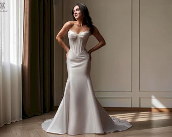 May include: A floor-length white gown featuring a structured, strapless corset-style bodice with vertical boning details and a sweetheart neckline. The skirt is fitted through the hips and flares out into a full, flowing hemline with a train.