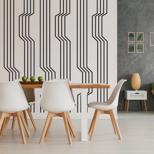 Line wall decals in a geometric pattern by Wall Star Graphics on a white wall in a minimalist interior.