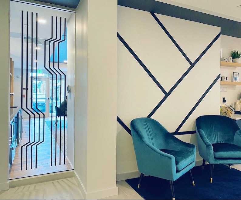 Line wall decals in a geometric pattern by Wall Star Graphics on a glass wall in a minimalist interior.