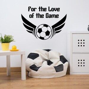 Soccer ball for the love of the game wall decal installed in a modern kids playroom.