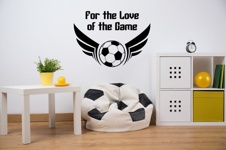 Soccer ball for the love of the game wall decal installed in a modern kids playroom.