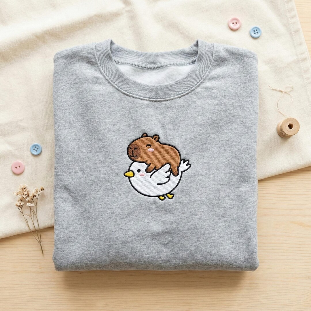 Capybara Riding a Duck Embroidered Sweatshirt, Cute Flying Capybara ...