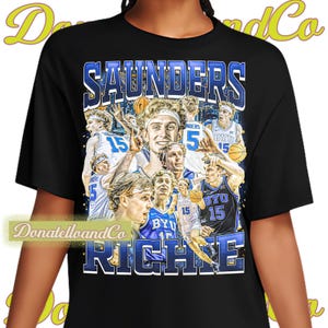 May include: Black t-shirt with a graphic print of a basketball team. The graphic features multiple players in blue and white uniforms with the text "SAUNDERS" and "RICHIE" printed on the shirt.
