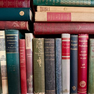 May include: A collection of antique books with various colors and sizes. The spines display titles like "History of England" and "Essentials of Pediatrics." The books are stacked and arranged, creating a vintage library aesthetic.